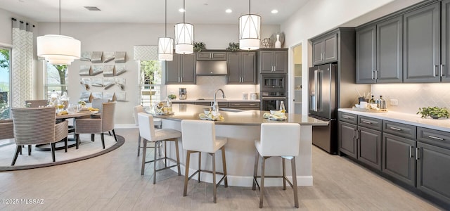 61784 E Travertine St, Oracle, AZ 85623 - kitchen with stainless steel appliances, healthy amount of natural light, a breakfast bar, decorative backsplash, and recessed lighting