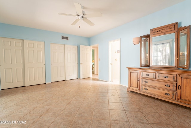 1857 W Dalehaven Cir, Tucson, AZ 85704 - bedroom with multiple closets, ceiling fan, and light tile patterned floors