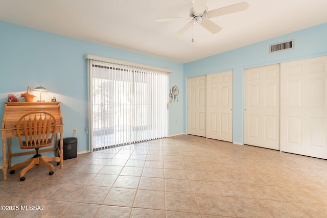 1857 W Dalehaven Cir, Tucson, AZ 85704 - bedroom featuring multiple closets, light tile patterned flooring, and ceiling fan