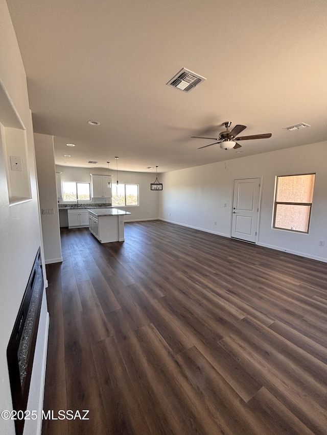 3152 E Andrada Rd, Vail, AZ 85641 - unfurnished living room featuring dark wood-style floors, a ceiling fan, and recessed lighting