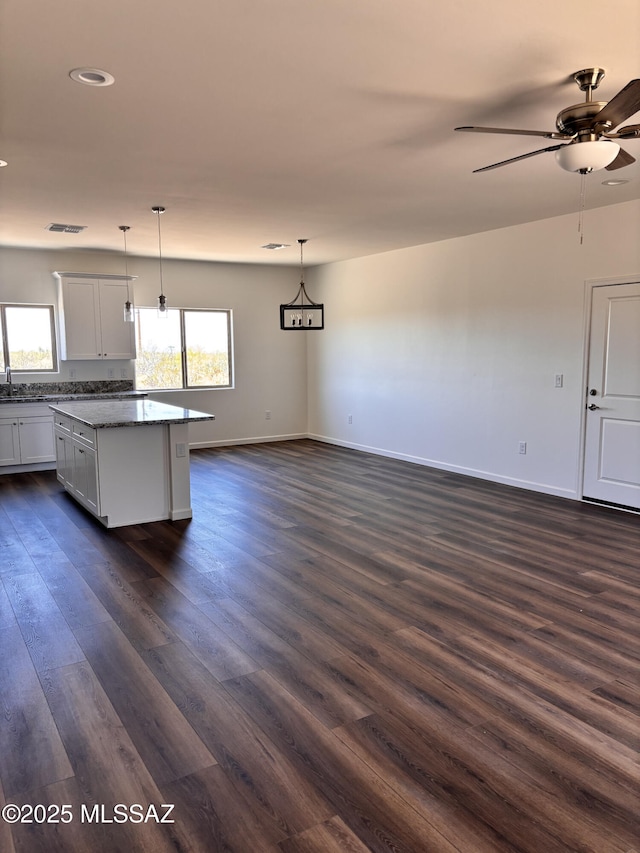 3152 E Andrada Rd, Vail, AZ 85641 - kitchen with dark wood-style floors, a center island, a ceiling fan, decorative light fixtures, and recessed lighting