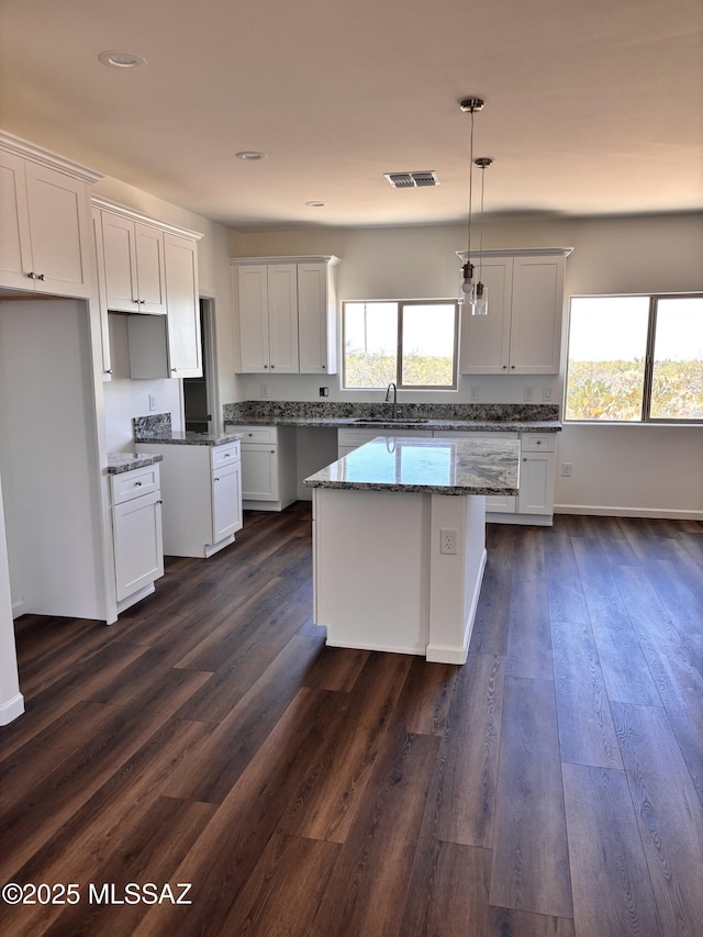 3152 E Andrada Rd, Vail, AZ 85641 - kitchen featuring healthy amount of natural light, stone countertops, white cabinets, and recessed lighting