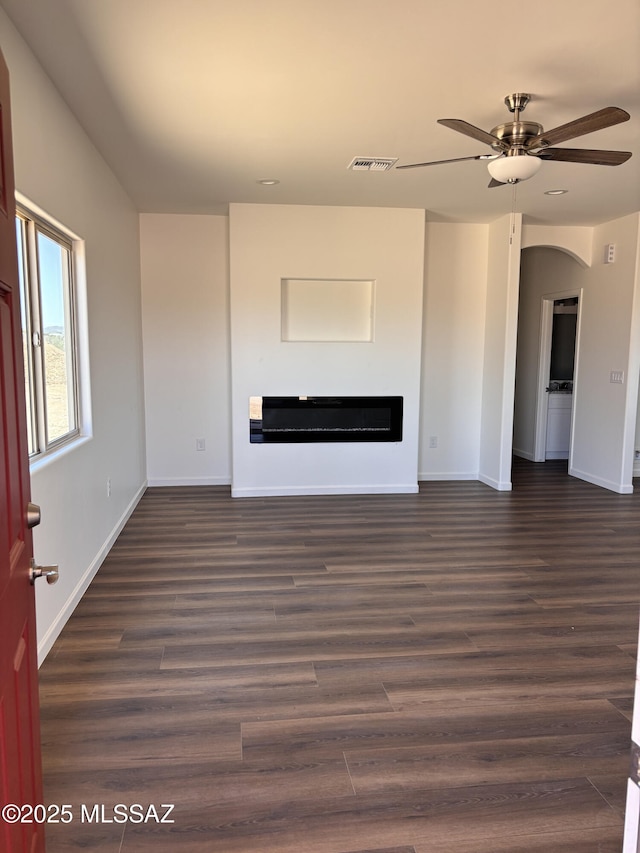 3152 E Andrada Rd, Vail, AZ 85641 - unfurnished living room featuring a glass covered fireplace, ceiling fan, and dark wood-style floors