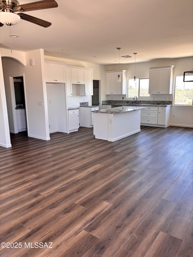 3152 E Andrada Rd, Vail, AZ 85641 - kitchen with a center island, dark wood-style flooring, a ceiling fan, and white cabinets