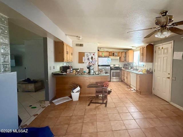 641 W Teton St, Tucson, AZ 85756 - kitchen with gas range, dishwasher, fridge, a peninsula, and a ceiling fan