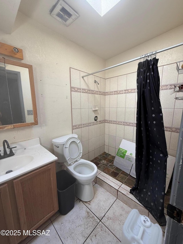 641 W Teton St, Tucson, AZ 85756 - bathroom featuring vanity, a tile shower, and tile patterned floors