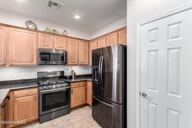 2257 E Skipping Rock Way, Tucson, AZ 85737 - kitchen with stainless steel appliances, light tile patterned floors, dark stone countertops, and recessed lighting