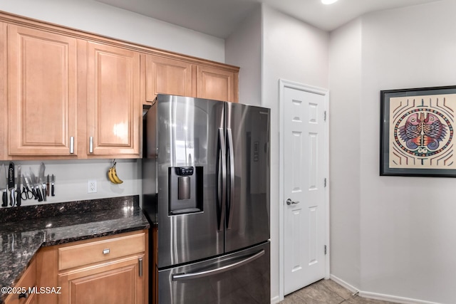 2257 E Skipping Rock Way, Tucson, AZ 85737 - kitchen with stainless steel fridge, dark stone countertops, and light tile patterned floors