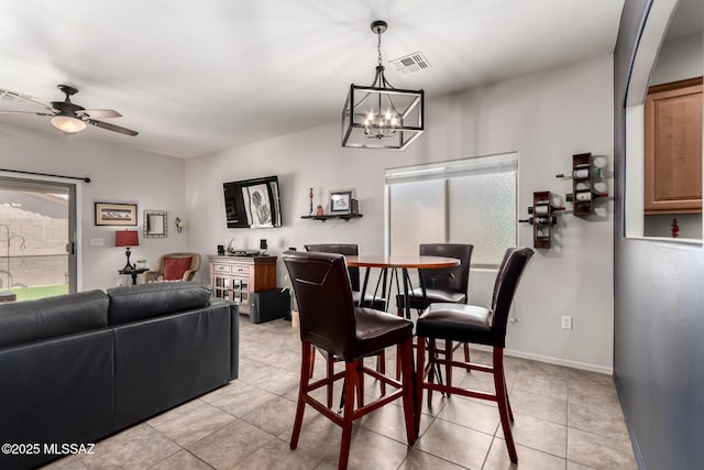2257 E Skipping Rock Way, Tucson, AZ 85737 - dining space with a ceiling fan, light tile patterned flooring, and a chandelier