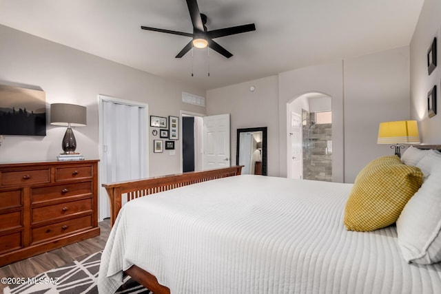 2257 E Skipping Rock Way, Tucson, AZ 85737 - bedroom with arched walkways, wood finished floors, and a ceiling fan