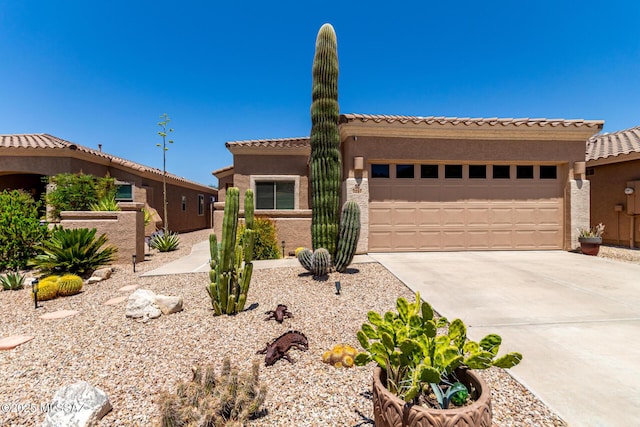 2257 E Skipping Rock Way, Tucson, AZ 85737 - view of front of property featuring driveway, a garage, stucco siding, and a tiled roof