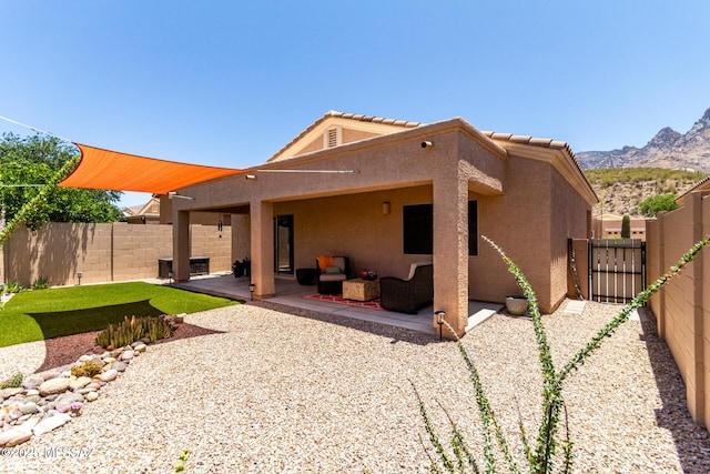 2257 E Skipping Rock Way, Tucson, AZ 85737 - rear view of property featuring stucco siding, a fenced backyard, a patio, and outdoor lounge area
