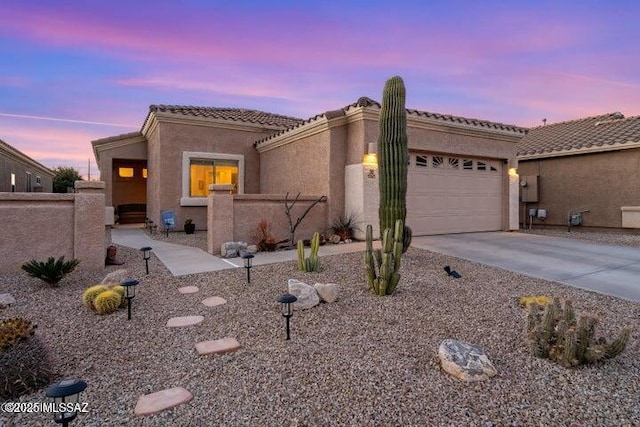 2257 E Skipping Rock Way, Tucson, AZ 85737 - view of front of house with an attached garage, driveway, stucco siding, and a tile roof