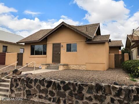 1048 E 7th St, Tucson, AZ 85719 - bungalow-style home featuring stucco siding and a gate