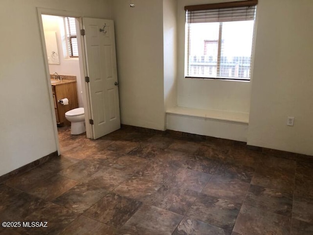1048 E 7th St, Tucson, AZ 85719 - spare room featuring stone finish floors
