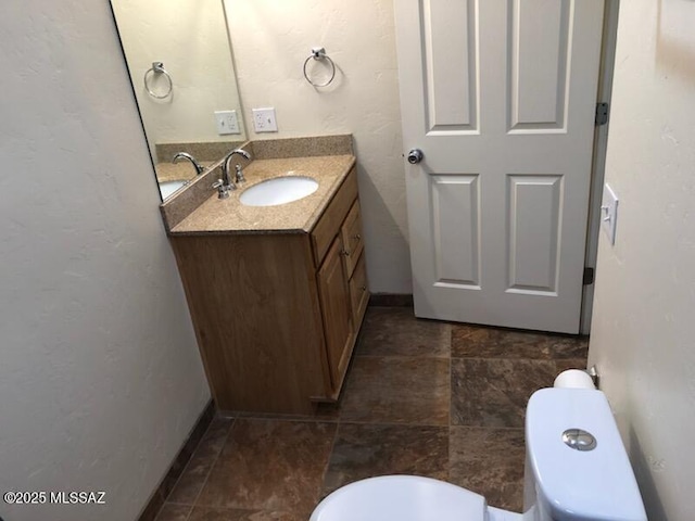 1048 E 7th St, Tucson, AZ 85719 - half bathroom with vanity and stone finish flooring