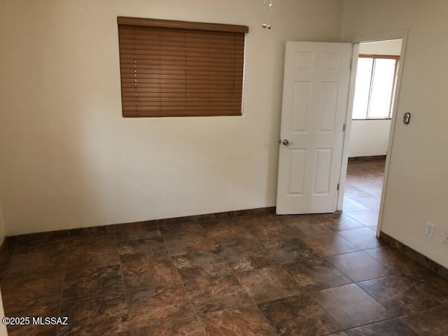 1048 E 7th St, Tucson, AZ 85719 - empty room featuring baseboards
