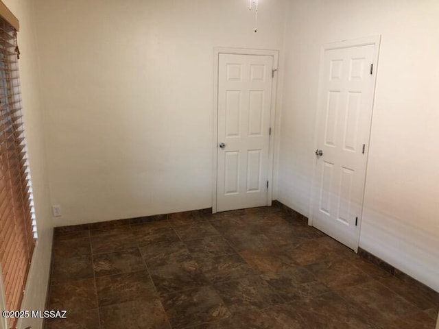 1048 E 7th St, Tucson, AZ 85719 - empty room featuring stone finish floors