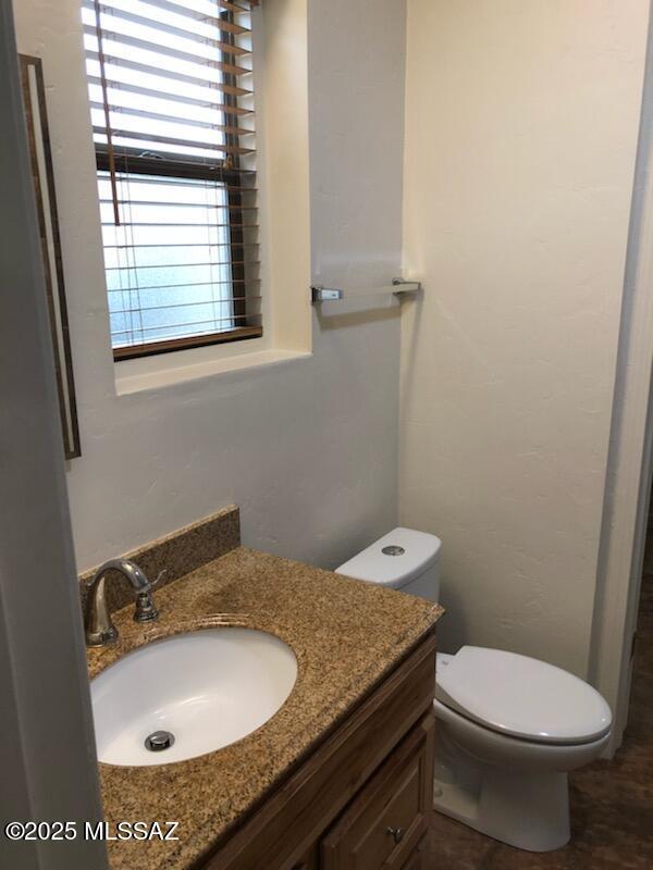 1048 E 7th St, Tucson, AZ 85719 - half bath featuring vanity and toilet