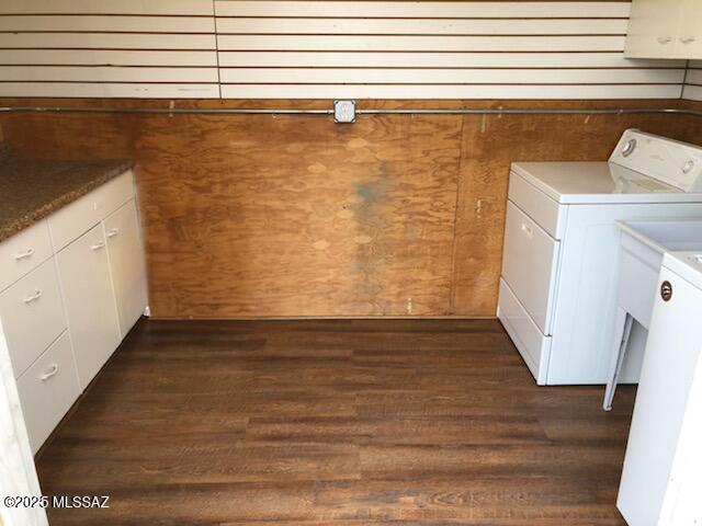 1048 E 7th St, Tucson, AZ 85719 - laundry area with washer and clothes dryer, dark wood finished floors, wooden walls, and cabinet space