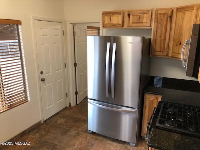 1048 E 7th St, Tucson, AZ 85719 - kitchen with stainless steel appliances, dark stone counters, and stone finish floors