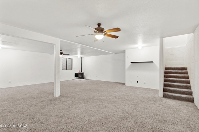807 N Manzanita Pl, Saint David, AZ 85630 - finished below grade area with a wood stove, stairs, a ceiling fan, and carpet flooring