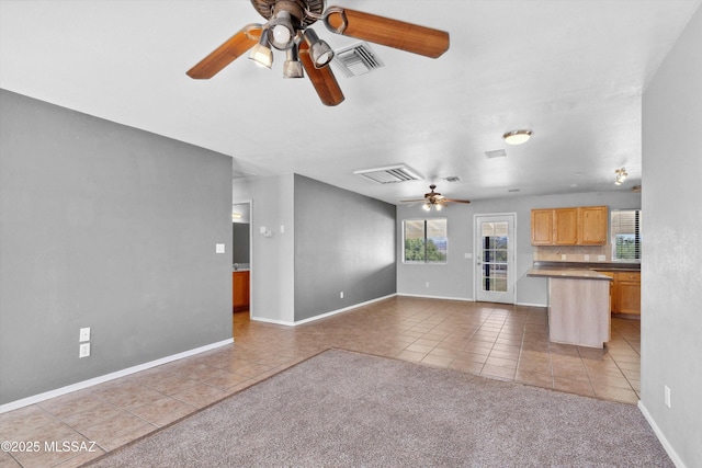807 N Manzanita Pl, Saint David, AZ 85630 - unfurnished living room with light tile patterned floors and a ceiling fan