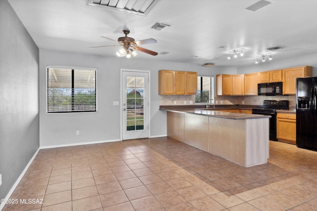 807 N Manzanita Pl, Saint David, AZ 85630 - kitchen with black appliances, a peninsula, light tile patterned floors, and decorative backsplash