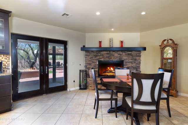 8142 N Modena Dr, Tucson, AZ 85742 - dining area with light tile patterned flooring, french doors, recessed lighting, and a fireplace