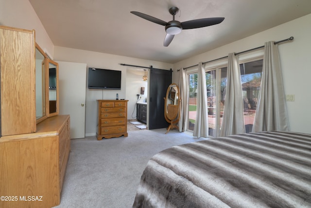 8142 N Modena Dr, Tucson, AZ 85742 - bedroom with a barn door, light colored carpet, access to outside, connected bathroom, and ceiling fan
