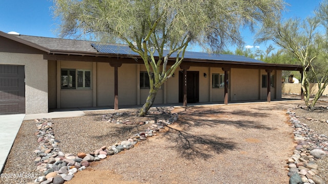 8142 N Modena Dr, Tucson, AZ 85742 - ranch-style house featuring stucco siding, roof mounted solar panels, and a patio