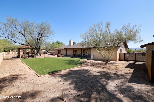 8142 N Modena Dr, Tucson, AZ 85742 - back of house featuring a gazebo, a chimney, stucco siding, and a patio