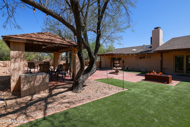 8142 N Modena Dr, Tucson, AZ 85742 - fenced backyard with a gazebo, a patio, and an outdoor fire pit