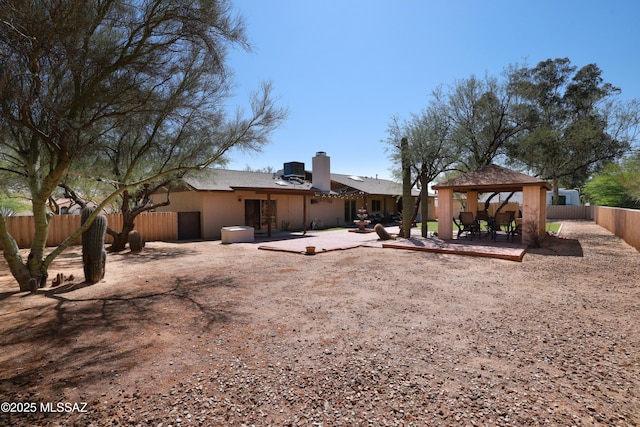 8142 N Modena Dr, Tucson, AZ 85742 - back of property with a gazebo, a patio area, and a chimney