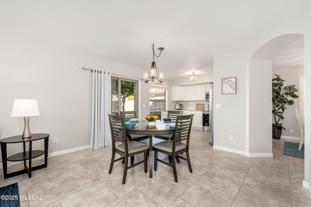 4660 E Torrey Pines Ln, Chandler, AZ 85249 - dining area featuring arched walkways, a chandelier, and light tile patterned floors