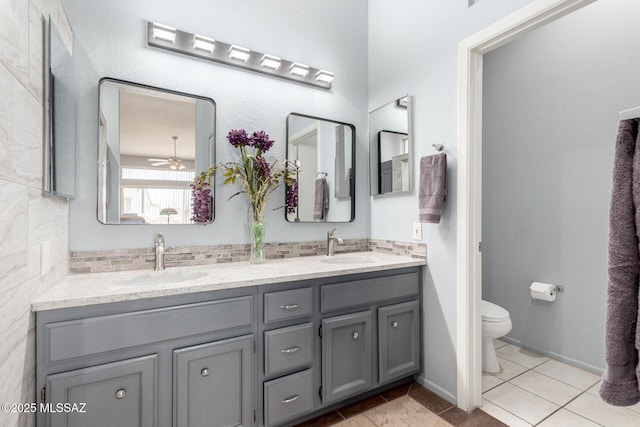 938 E Grass Meadow Pl, Oro Valley, AZ 85755 - full bath featuring double vanity, decorative backsplash, tile patterned flooring, and ceiling fan