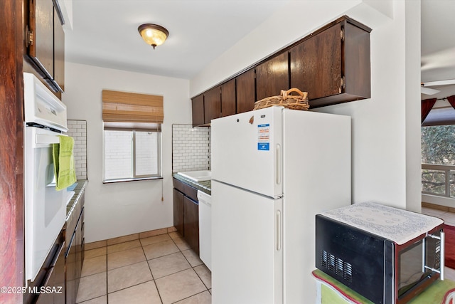 8450 E Old Spanish Trl Apt 154, Tucson, AZ 85710 - kitchen with white appliances, dark brown cabinets, light countertops, decorative backsplash, and light tile patterned floors