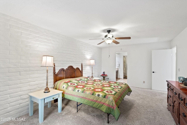 8450 E Old Spanish Trl Apt 154, Tucson, AZ 85710 - bedroom featuring light colored carpet, brick wall, and a ceiling fan