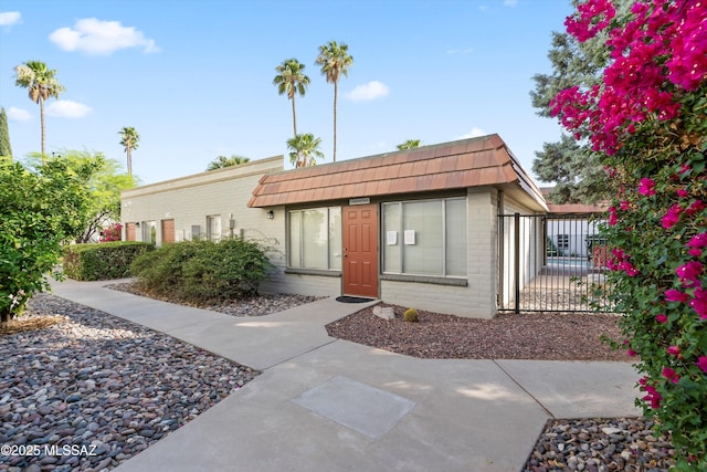 8450 E Old Spanish Trl Apt 154, Tucson, AZ 85710 - view of front of property with mansard roof and brick siding