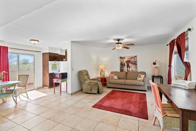8450 E Old Spanish Trl Apt 154, Tucson, AZ 85710 - living area with light tile patterned floors and a ceiling fan