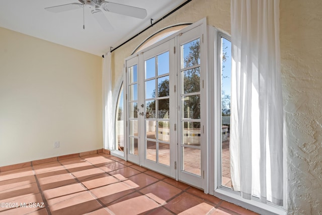 5015 N Via Condesa, Tucson, AZ 85718 - empty room with a textured wall, french doors, tile patterned floors, and a ceiling fan