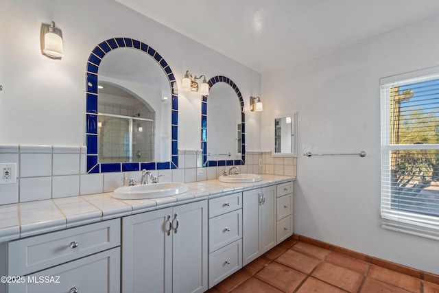 5015 N Via Condesa, Tucson, AZ 85718 - full bath with backsplash, double vanity, a stall shower, and tile patterned floors