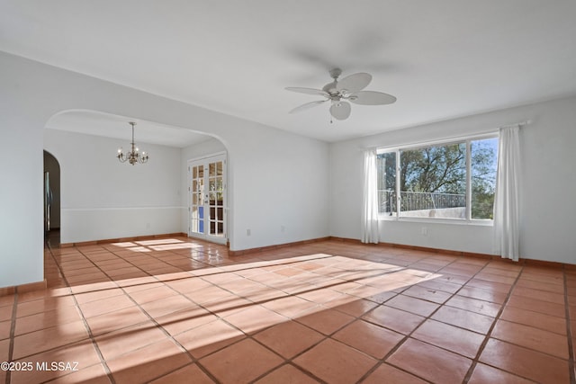 5015 N Via Condesa, Tucson, AZ 85718 - tiled spare room featuring arched walkways, ceiling fan, and a chandelier
