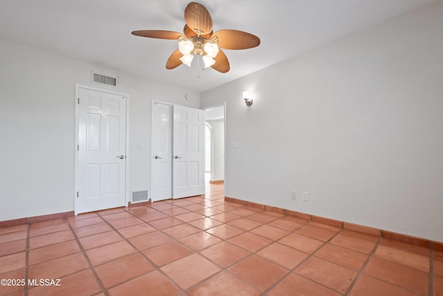 5015 N Via Condesa, Tucson, AZ 85718 - unfurnished bedroom with light tile patterned flooring and ceiling fan