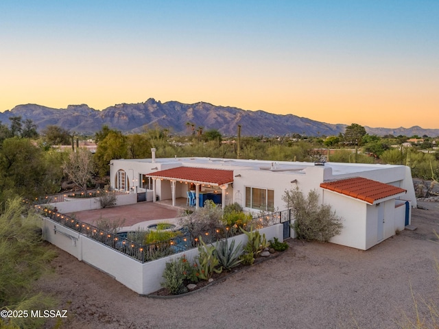 5015 N Via Condesa, Tucson, AZ 85718 - view of front of house with a tiled roof, stucco siding, a mountain view, driveway, and a garage