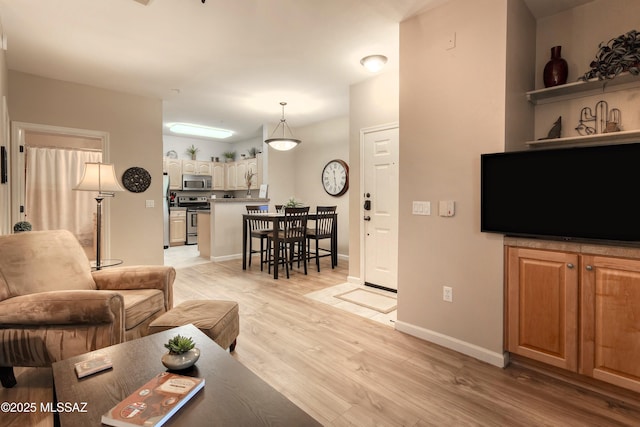1500 E Pusch Wilderness Dr Unit 2103, Tucson, AZ 85737 - living area featuring light wood-style flooring and baseboards