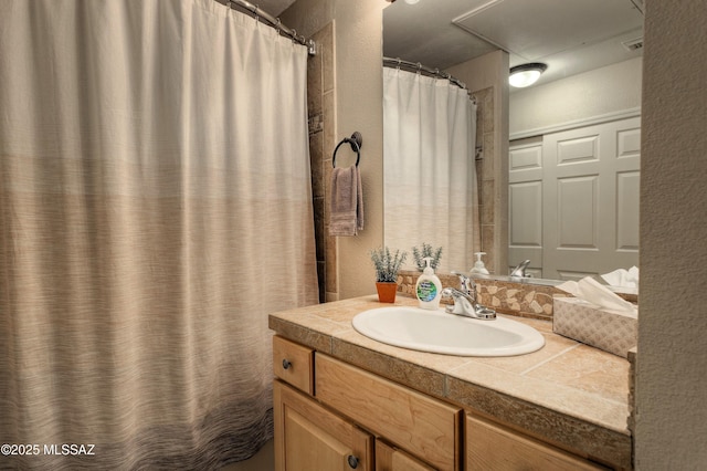 1500 E Pusch Wilderness Dr Unit 2103, Tucson, AZ 85737 - full bath featuring vanity, a textured wall, and curtained shower