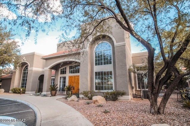 1500 E Pusch Wilderness Dr Unit 2103, Tucson, AZ 85737 - view of front facade with stucco siding, uncovered parking, and a tile roof
