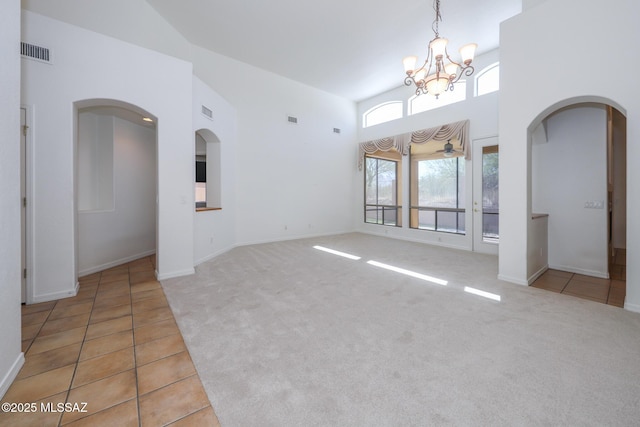 14085 E Copper Mesa Ct, Vail, AZ 85641 - tiled spare room with a towering ceiling, a chandelier, arched walkways, and carpet