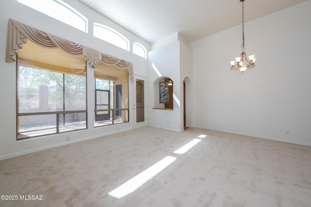 14085 E Copper Mesa Ct, Vail, AZ 85641 - empty room with arched walkways, carpet floors, and a chandelier